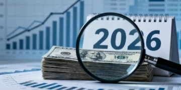 US dollar bills, magnifying glass, and 2026 calendar symbolizing upcoming capital gains tax changes